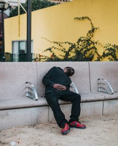 Urban Napping: Peacefully sleeping in a public bench.